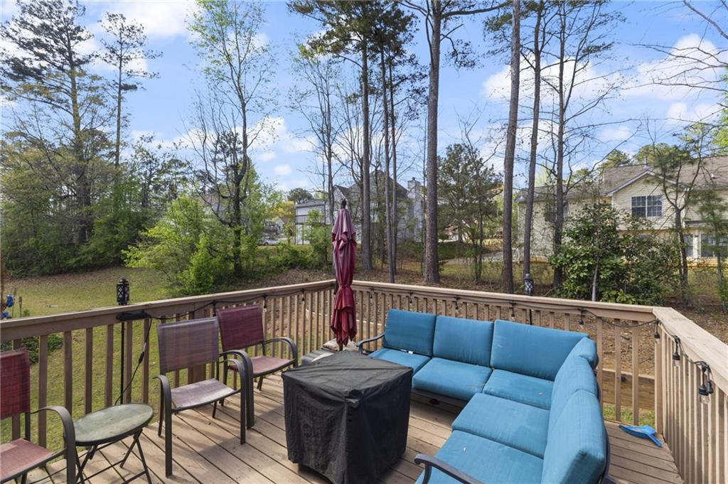 4008 Lindsey Lane Rex, GA 30273 - Photo 31 of 34 a balcony with wooden floor and outdoor seating