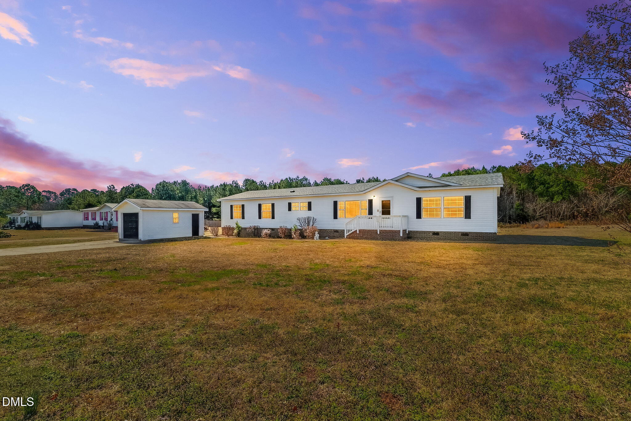 10015 Smith Road Middlesex, NC 27557 - Photo 2 of 48 a front view of a house with a garden