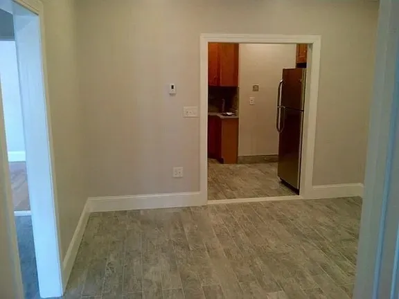 an empty room with closet and a bathroom