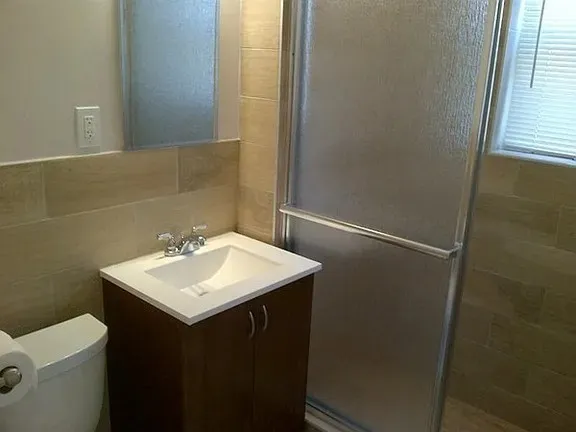 a bathroom with a sink toilet and mirror