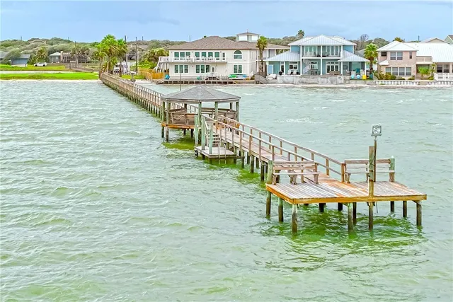 a view of a lake with a table and chairs