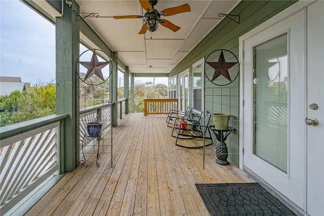 a view of a porch with wooden floor and furniture