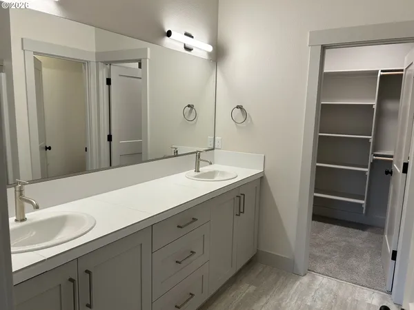 a bathroom with a sink double vanity and a mirror