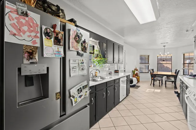 a kitchen with a sink dishwasher stove and cabinets