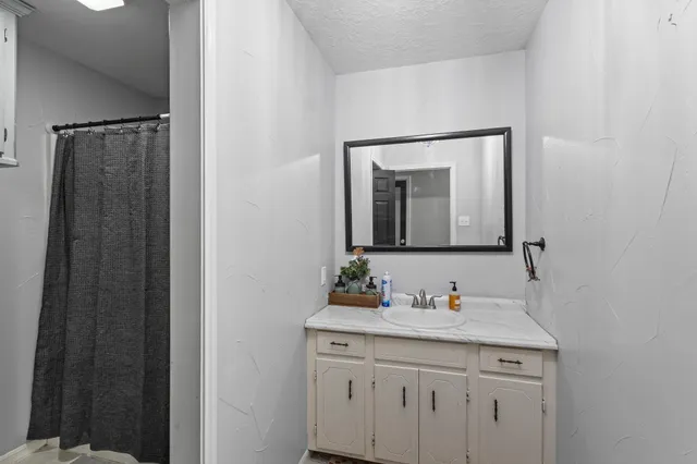 a bathroom with a sink and mirror