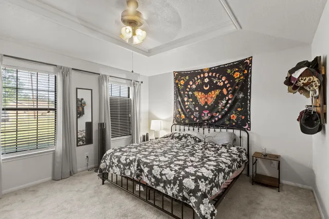 a bedroom with a bed and a chandelier
