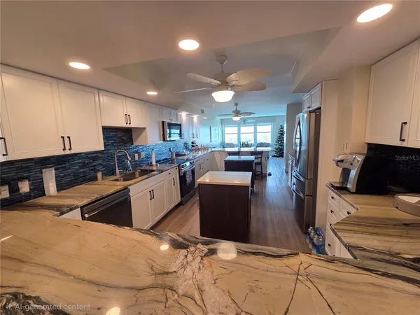 a kitchen with stainless steel appliances kitchen island granite countertop a refrigerator stove microwave and sink