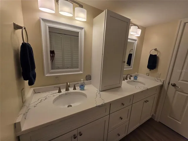 a bathroom with a double vanity sink and mirror