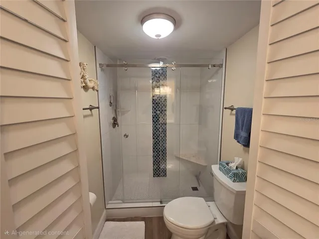 a bathroom with a toilet and a shower