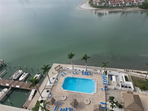 a patio with a table and chairs under an umbrella