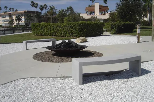 a view of a lake and a car parked on the street next to a yard