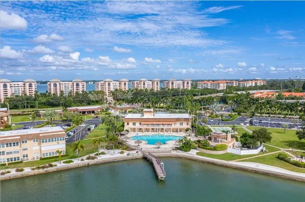 a view of swimming pool with outdoor seating and lake view
