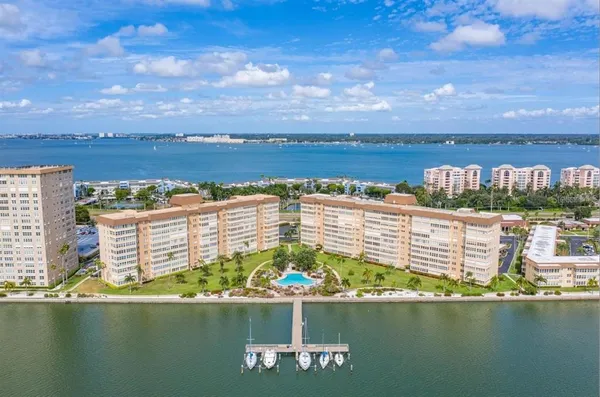 a living room with fireplace furniture and a large window