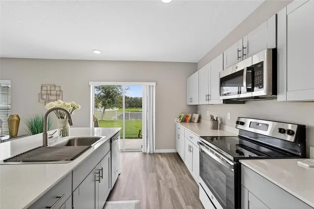 a kitchen with stainless steel appliances a refrigerator sink and cabinets
