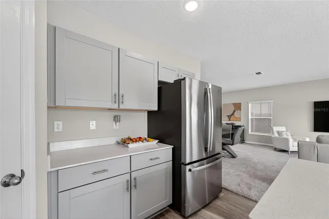 a bedroom with a large bed and a flat tv screen on dresser