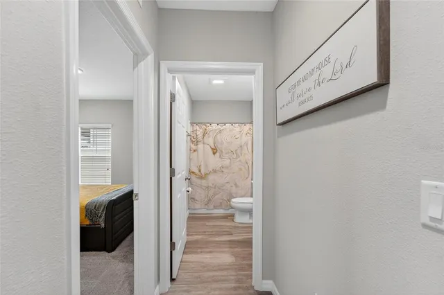 a bedroom with a bed and a lamp on table