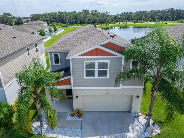 a backyard of a house with outdoor seating and flowers