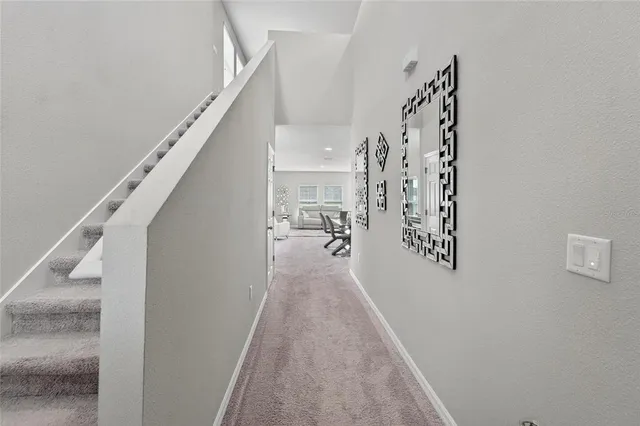a view of a hallway with wooden floor and entryway