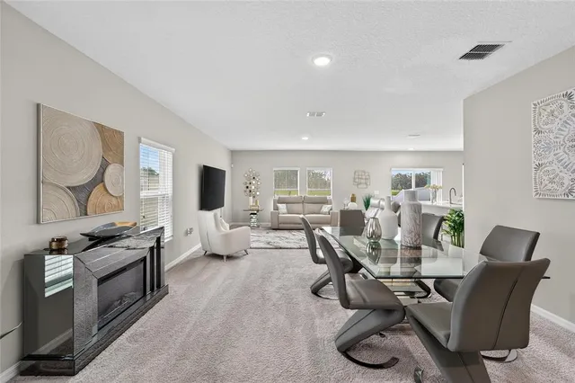 a dining room with furniture and wooden floor