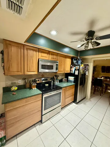 a kitchen with stainless steel appliances granite countertop a sink and cabinets