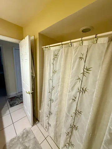 a room with pool table and wooden floor