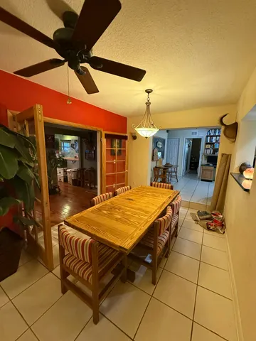 a view of a kitchen with stainless steel appliances granite countertop a sink and a counter top space