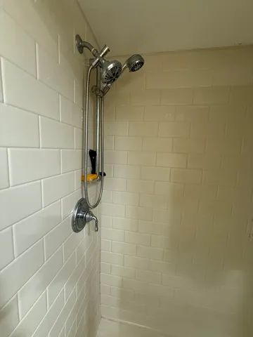 a view of a dining room with furniture and a chandelier