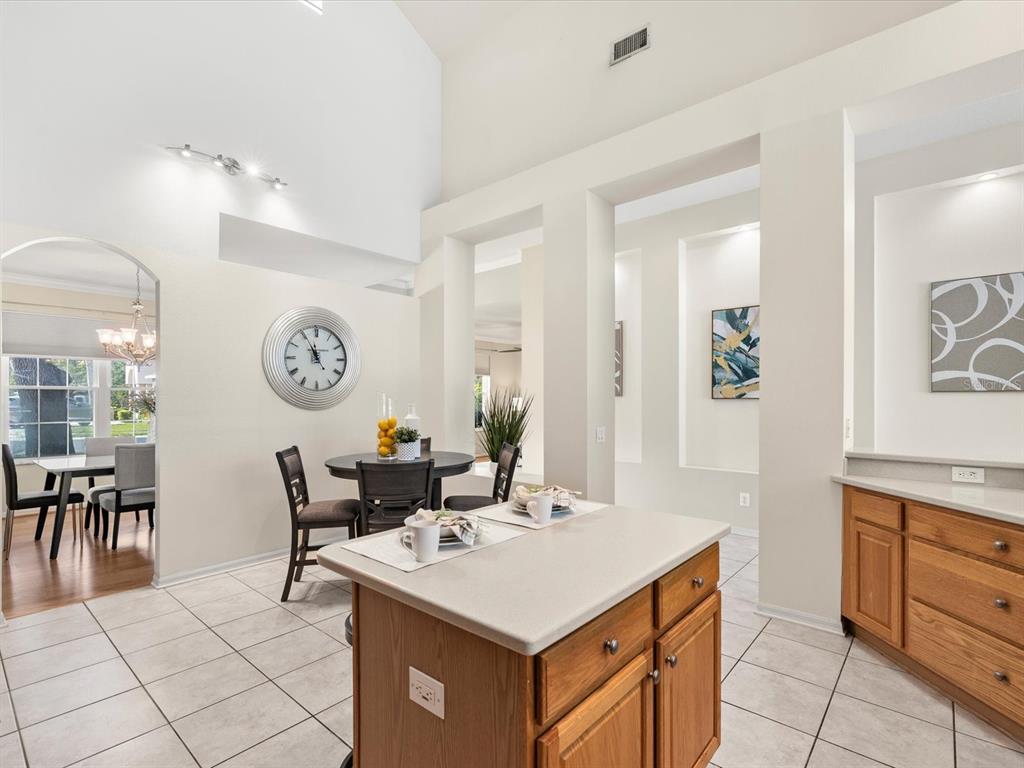 7935 Calindra Court Trinity, FL 34655 - Photo 14 of 52 a kitchen with a cabinets and chairs