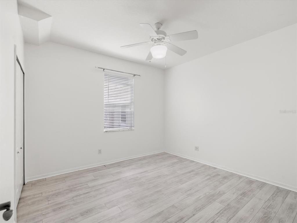 7935 Calindra Court Trinity, FL 34655 - Photo 24 of 52 an empty room with wooden floor and windows