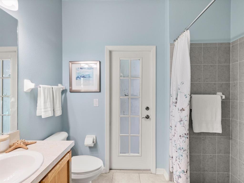 7935 Calindra Court Trinity, FL 34655 - Photo 28 of 52 a bathroom with a sink toilet vanity and shower