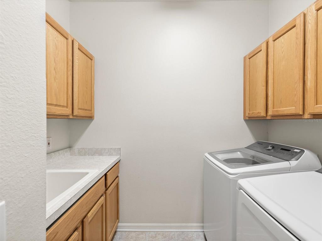 7935 Calindra Court Trinity, FL 34655 - Photo 30 of 52 a utility room with dryer and washer