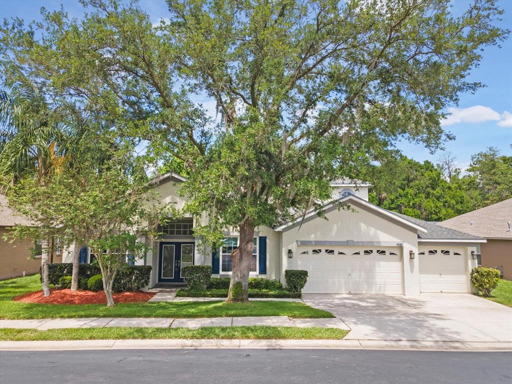 7935 Calindra Court Trinity, FL 34655 - Photo 42 of 52 a front view of a house with a yard