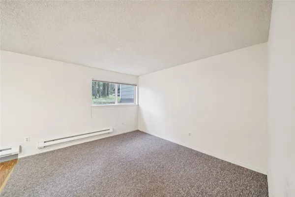 an empty room with a empty space and a window