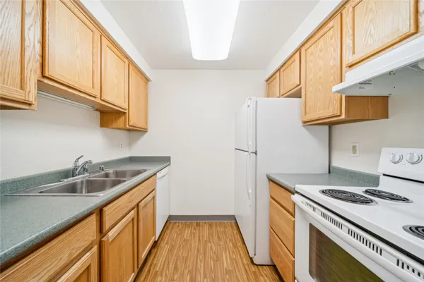 a kitchen with granite countertop a sink and cabinets