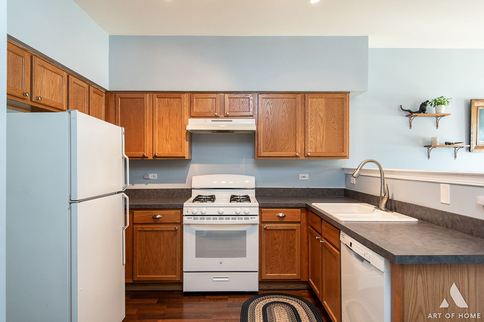 169 Braxton Lane Aurora, IL 60504 - Photo 10 of 26 a kitchen with a sink a stove a refrigerator and cabinets