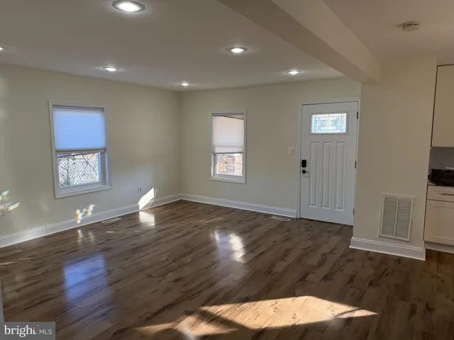 a view of an empty room and wooden floor