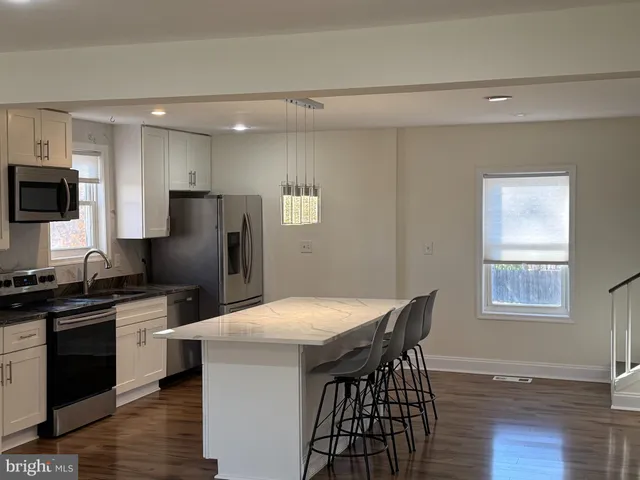 a kitchen with stainless steel appliances a refrigerator stove microwave and sink