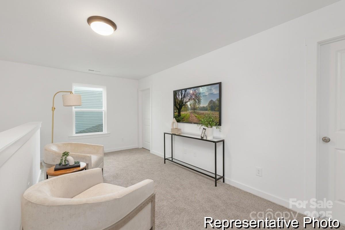 128 Peak Vw Road, Unit 5P Statesville, NC 28677 - Photo 13 of 28 a living room with furniture and a flat screen tv