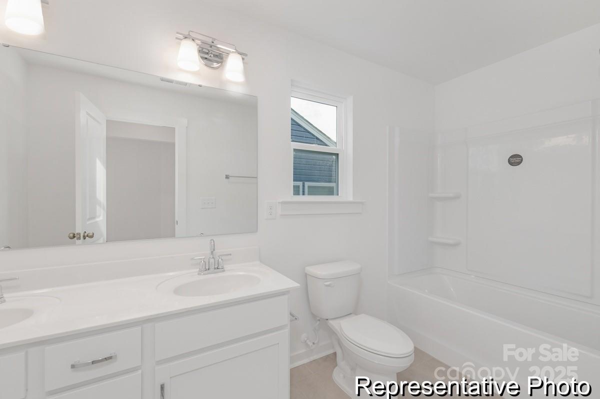 128 Peak Vw Road, Unit 5P Statesville, NC 28677 - Photo 28 of 28 a bathroom with a sink a toilet and shower