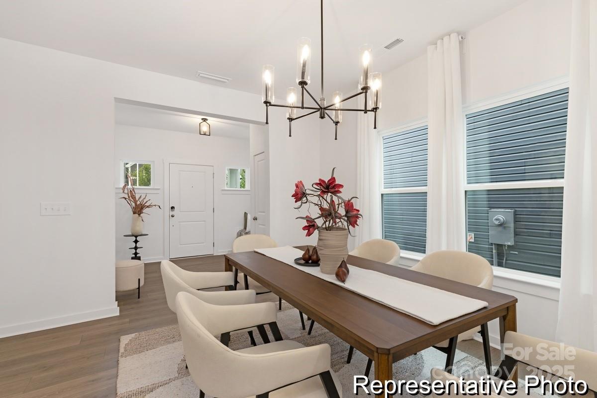 128 Peak Vw Road, Unit 5P Statesville, NC 28677 - Photo 6 of 28 a view of a dining room with furniture and wooden floor