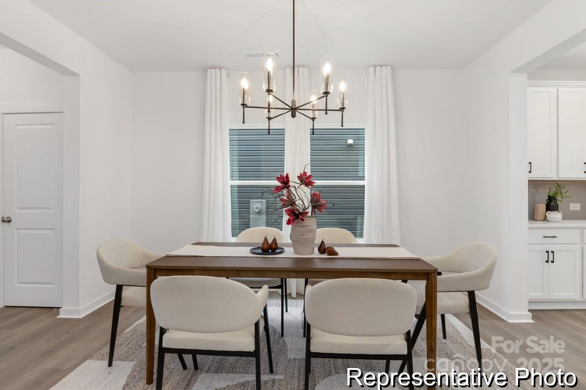 128 Peak Vw Road, Unit 5P Statesville, NC 28677 - Photo 8 of 28 a view of a dining room with furniture and wooden floor