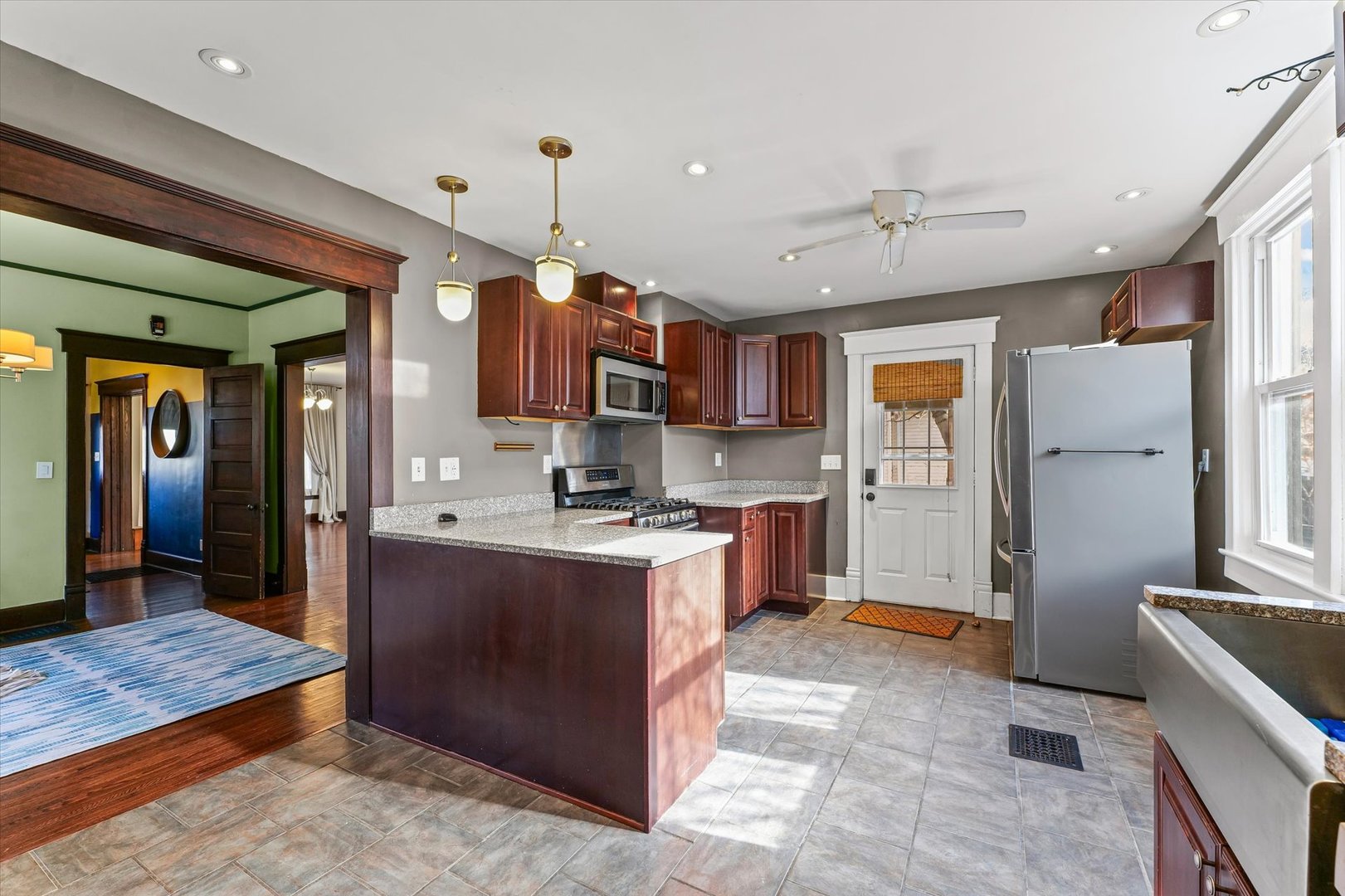 407 West High Street Urbana, IL 61801 - Photo 12 of 28 a kitchen with stainless steel appliances granite countertop a refrigerator a stove top oven a sink and dishwasher