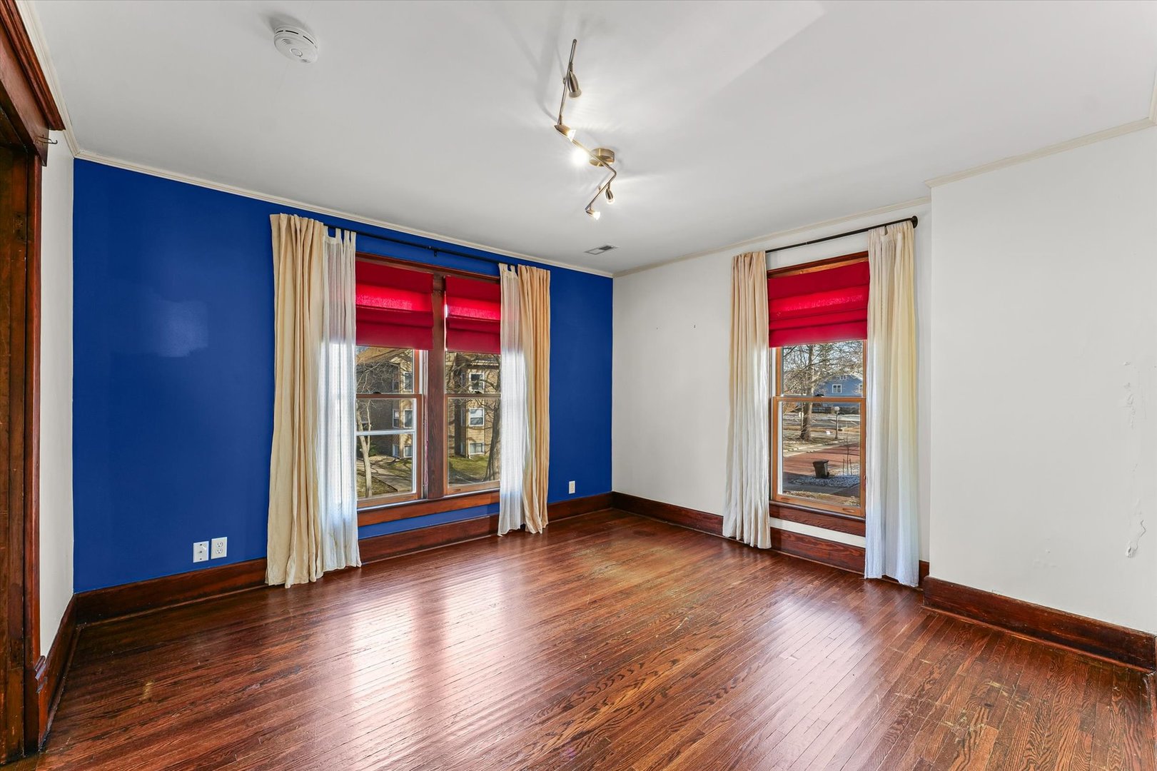 407 West High Street Urbana, IL 61801 - Photo 14 of 28 an empty room with wooden floor and windows