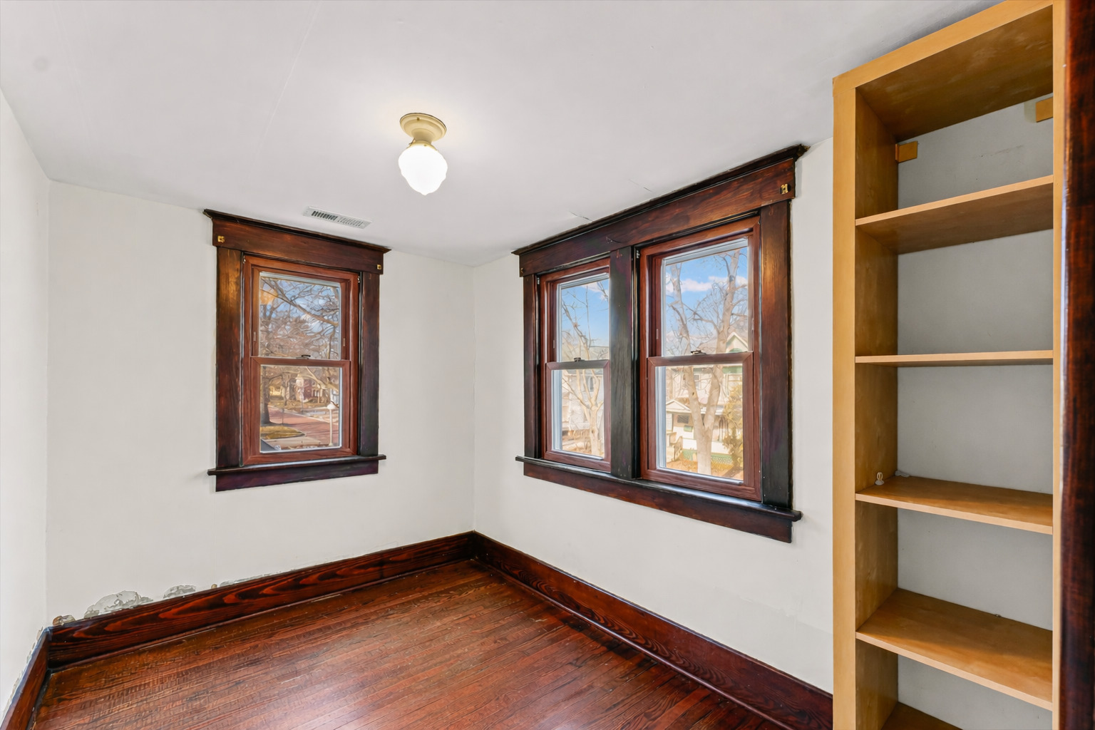 407 West High Street Urbana, IL 61801 - Photo 16 of 28 a view of an empty room with wooden floor and a window