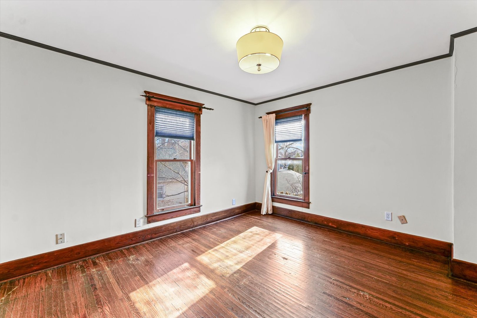 407 West High Street Urbana, IL 61801 - Photo 17 of 28 an empty room with wooden floor and windows