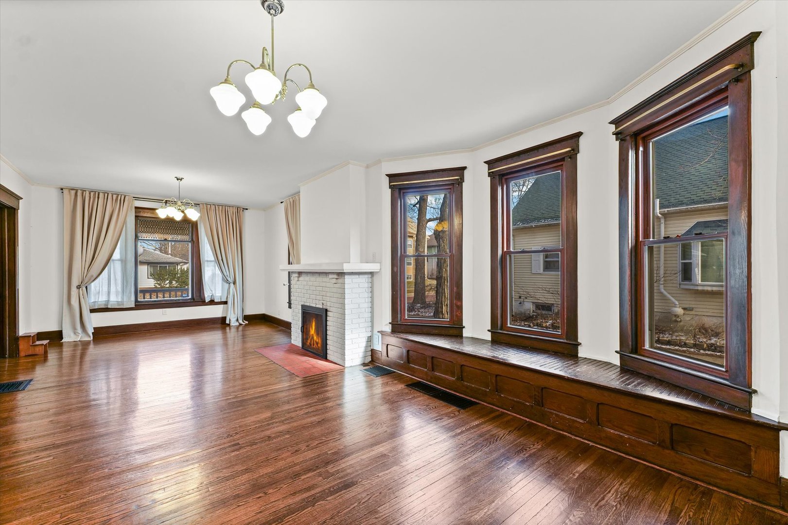 407 West High Street Urbana, IL 61801 - Photo 5 of 28 a view of a livingroom with wooden floor and a large window