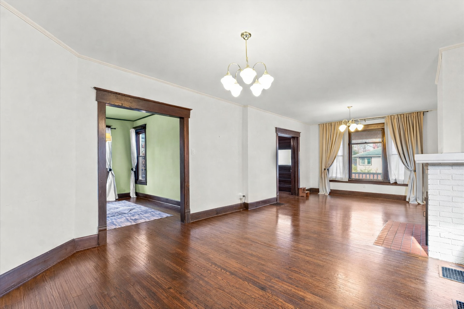 407 West High Street Urbana, IL 61801 - Photo 6 of 28 a view of an empty room with wooden floor and a window