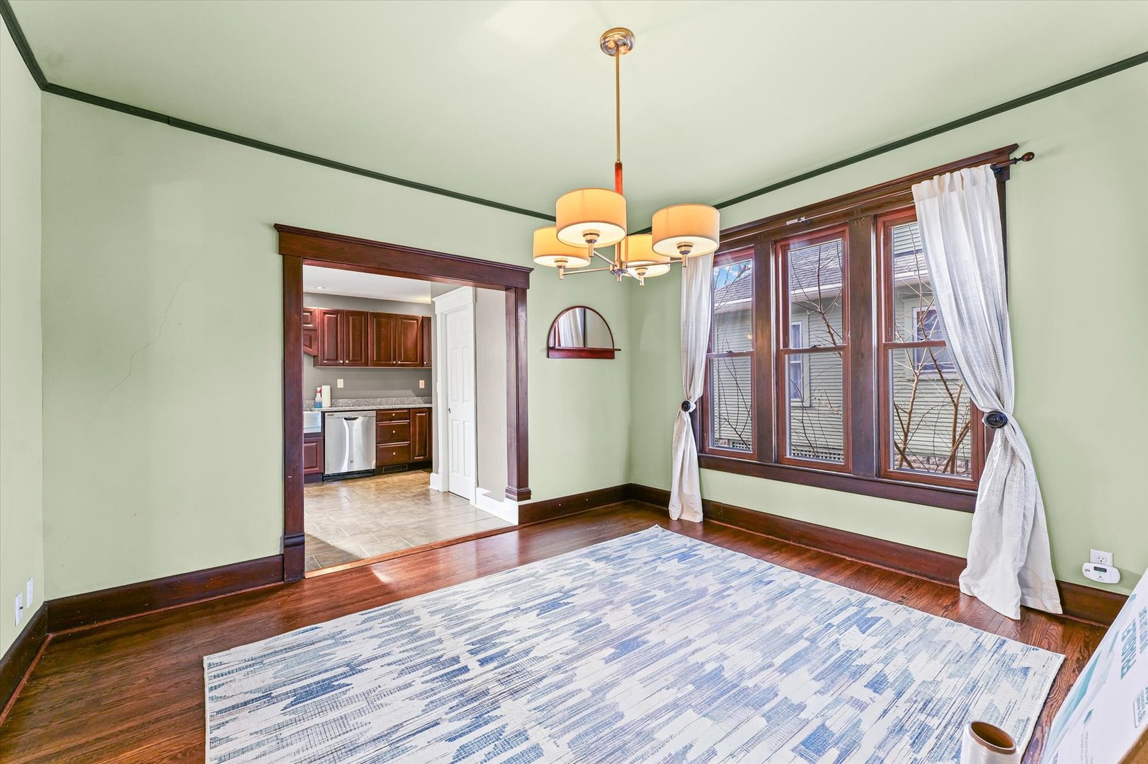 407 West High Street Urbana, IL 61801 - Photo 7 of 28 a view of an empty room with window and wooden floor