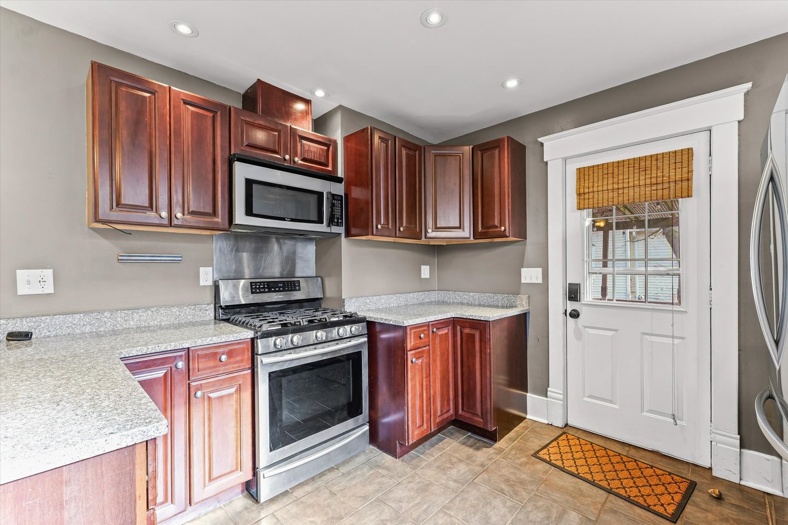 407 West High Street Urbana, IL 61801 - Photo 10 of 28 a kitchen with stainless steel appliances granite countertop wooden cabinets a stove top oven a sink and dishwasher