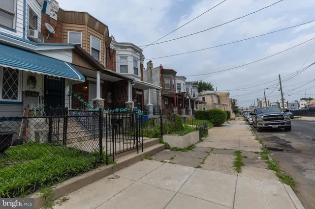 a view of a street with sitting area and a small yard
